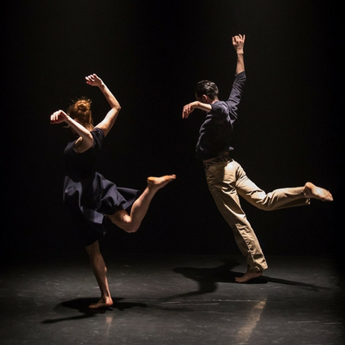 Dancers in Seek with back leg in the air, backs to the camera