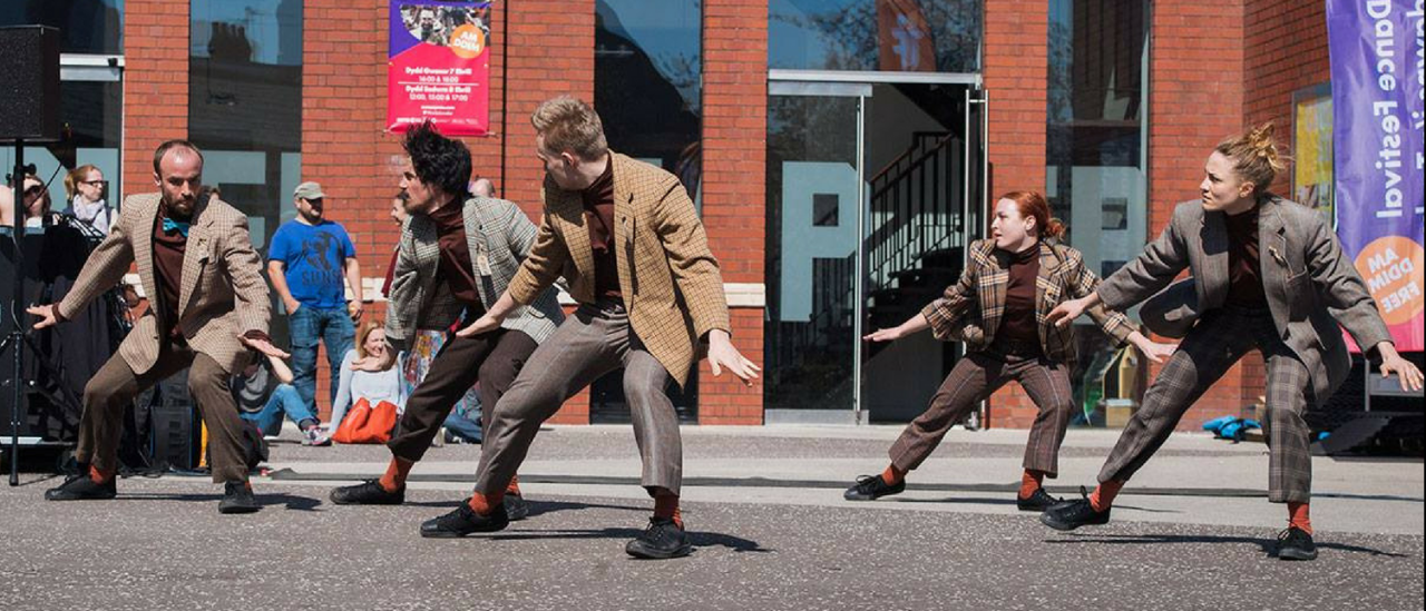 Animatorium performed outside chapter arts centre, 5 dancers crouched