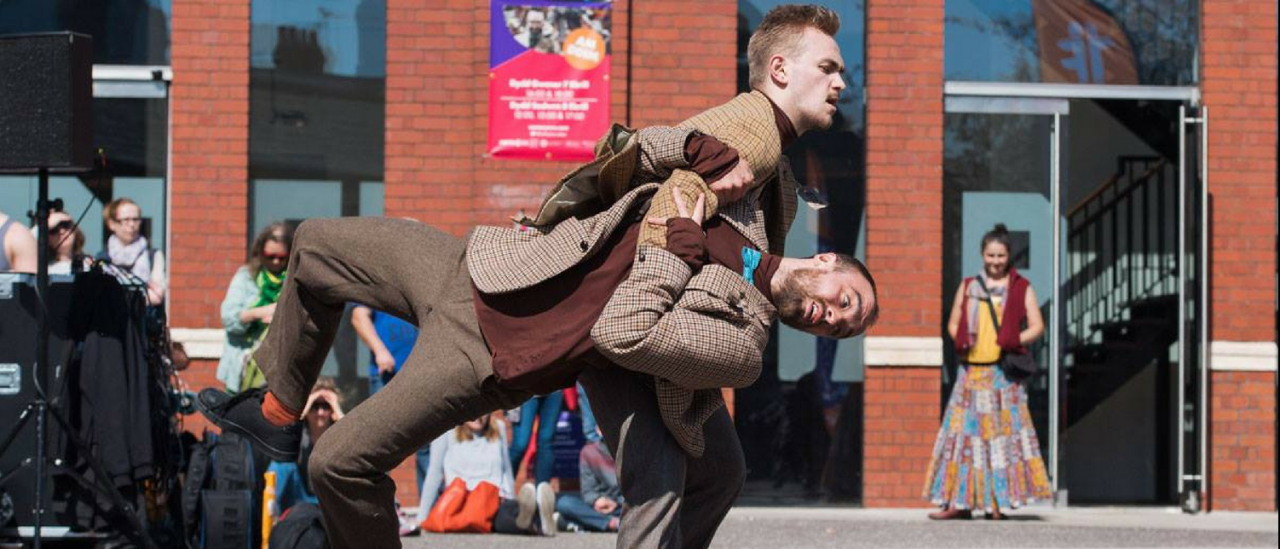 Animatorium performed outside chapter arts centre, 2 dancers pulling each over