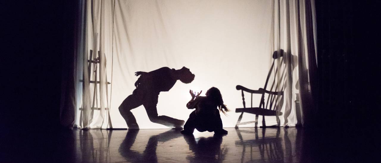 a dancer in front of a silhouette of another dancer behind 