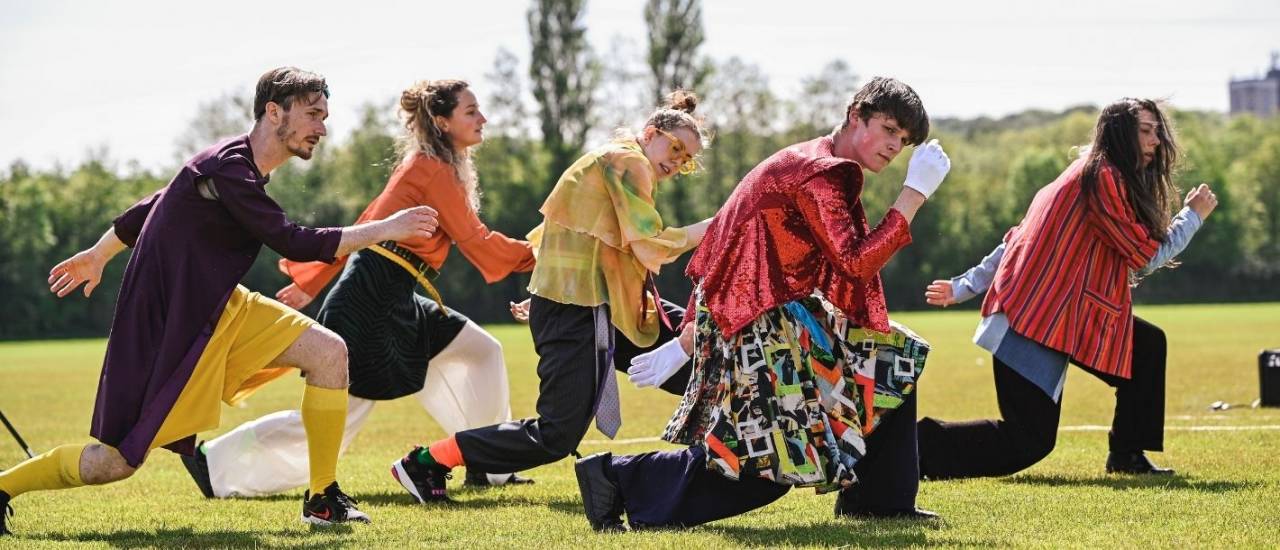 group of 5 dancers, one foot in front of the other and crouched