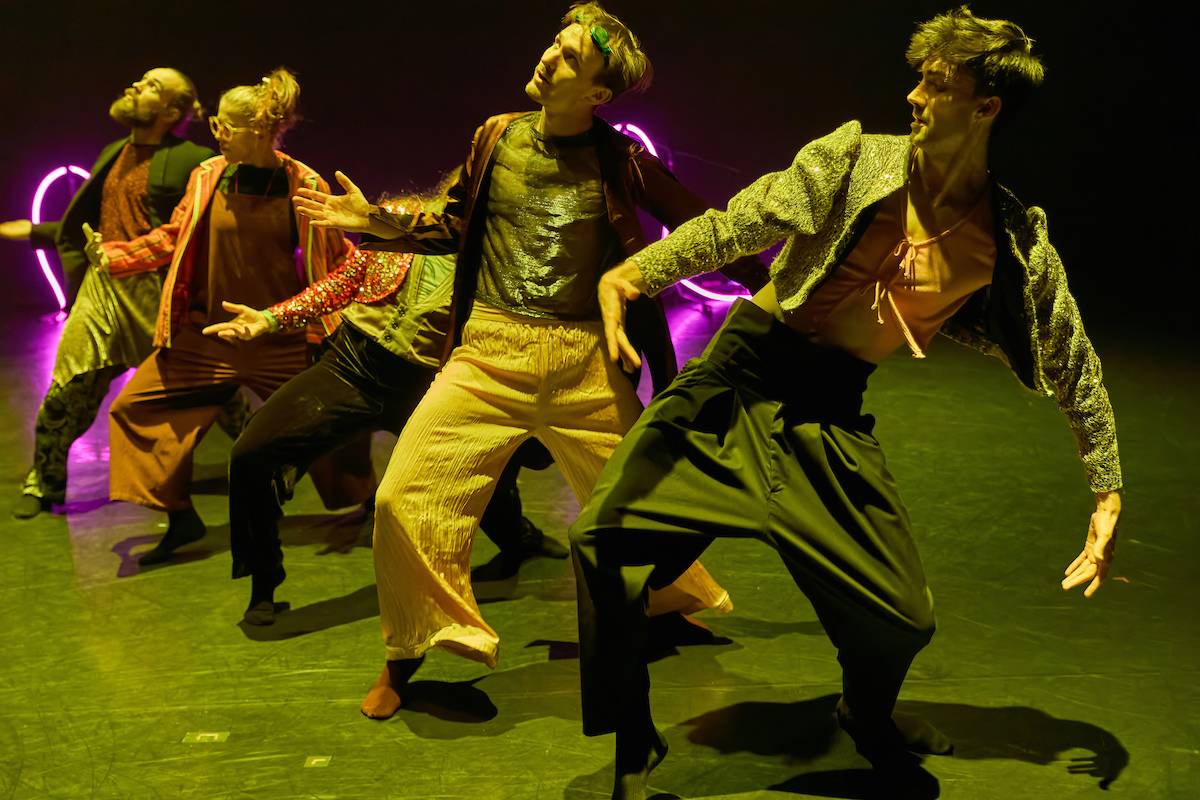 five dancers groove in a diagonal line away from the camera under golden light