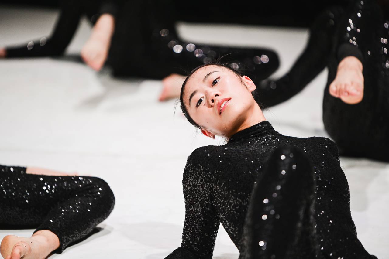 Jill Goh leans back in a black catsuit