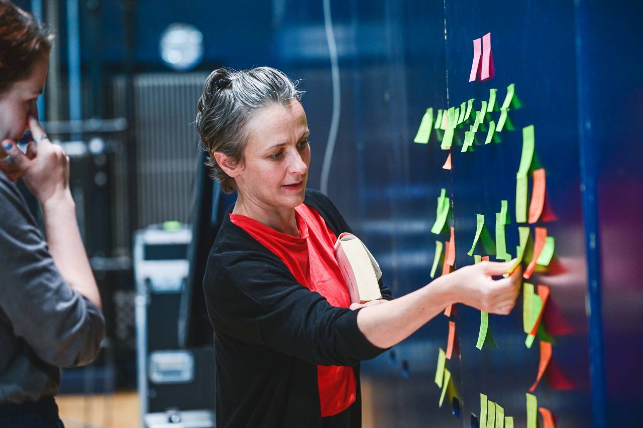 Deb Light looks at her postit note wall