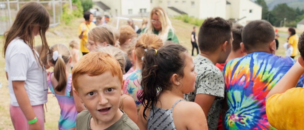 Group of young people, one boy looking to camera