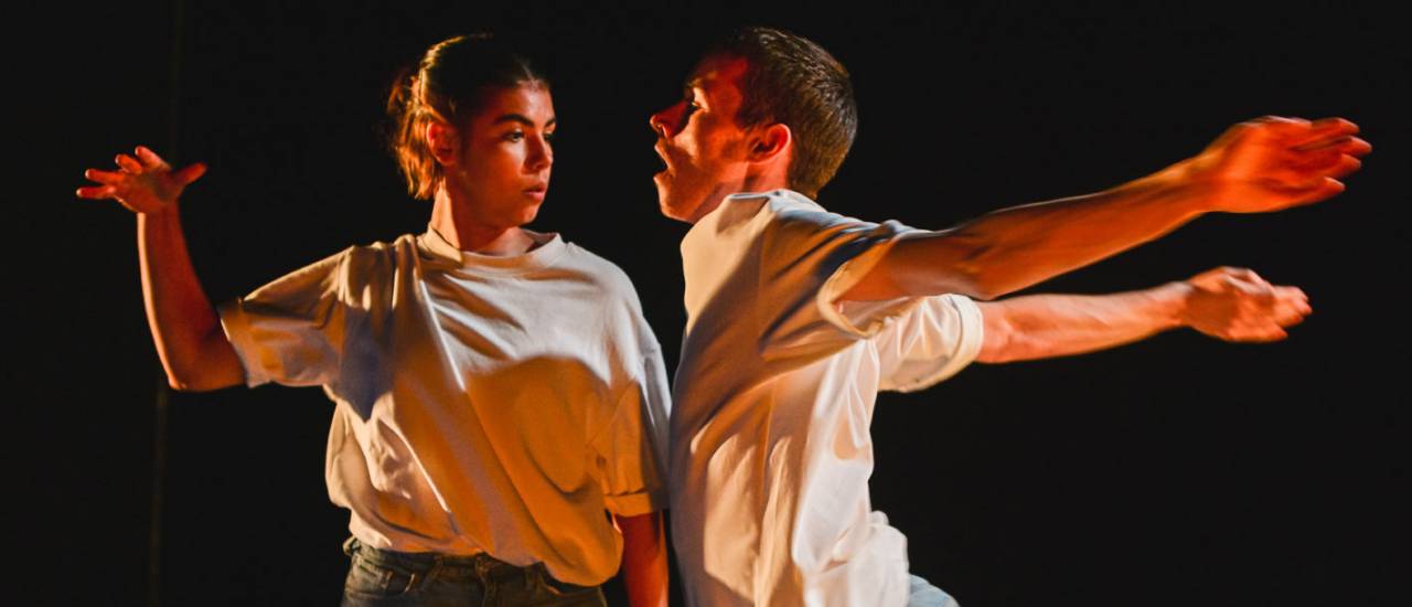 two dancers in white tshirts