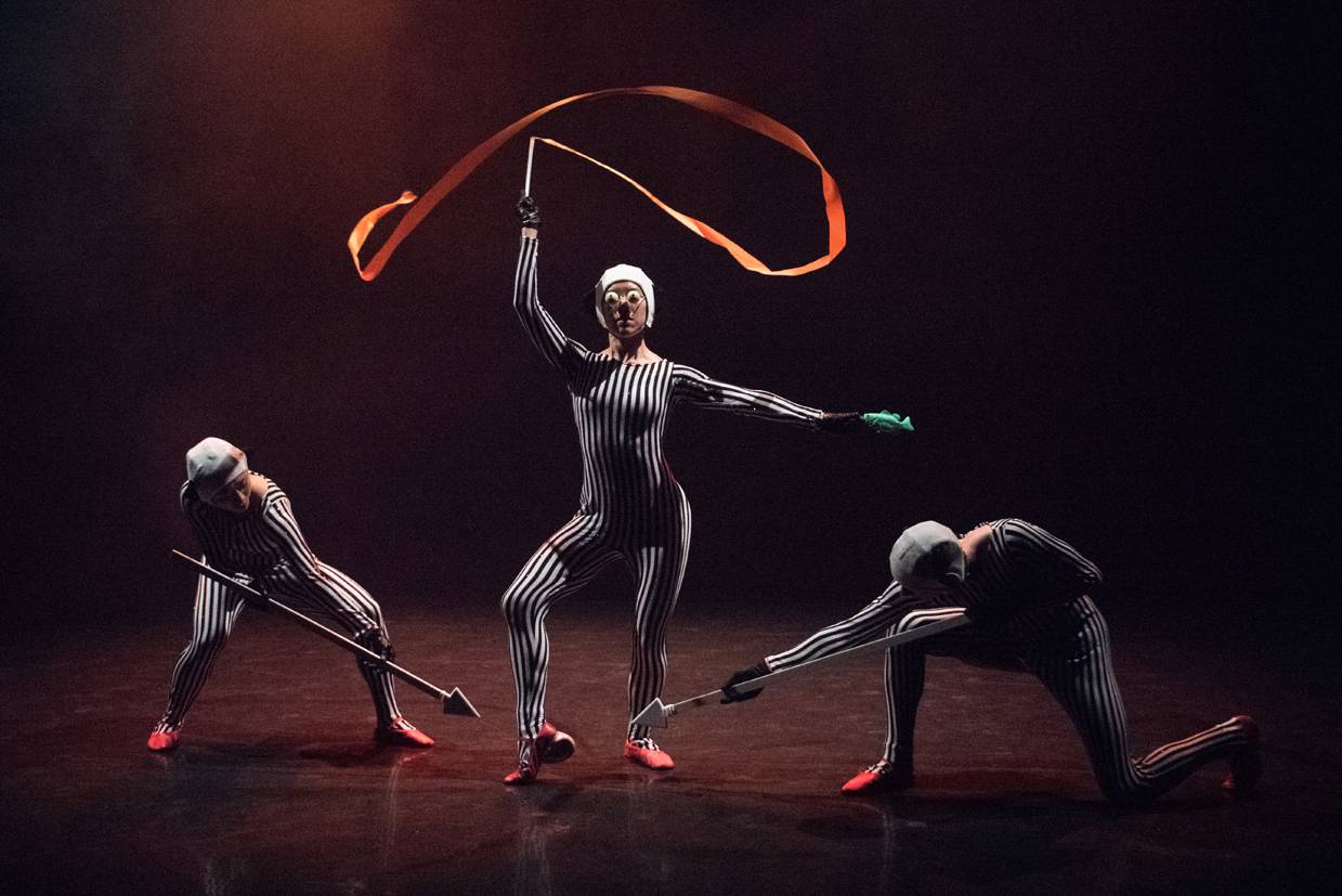 dancers in striped costumes with ribbons and arrows