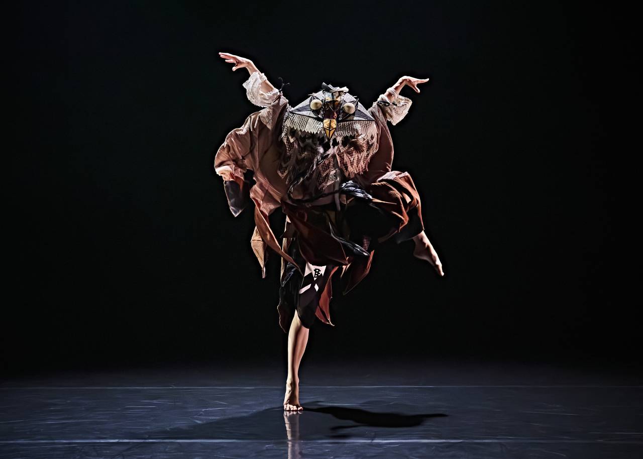 riz dressed as an eagle, arms thrown above their head