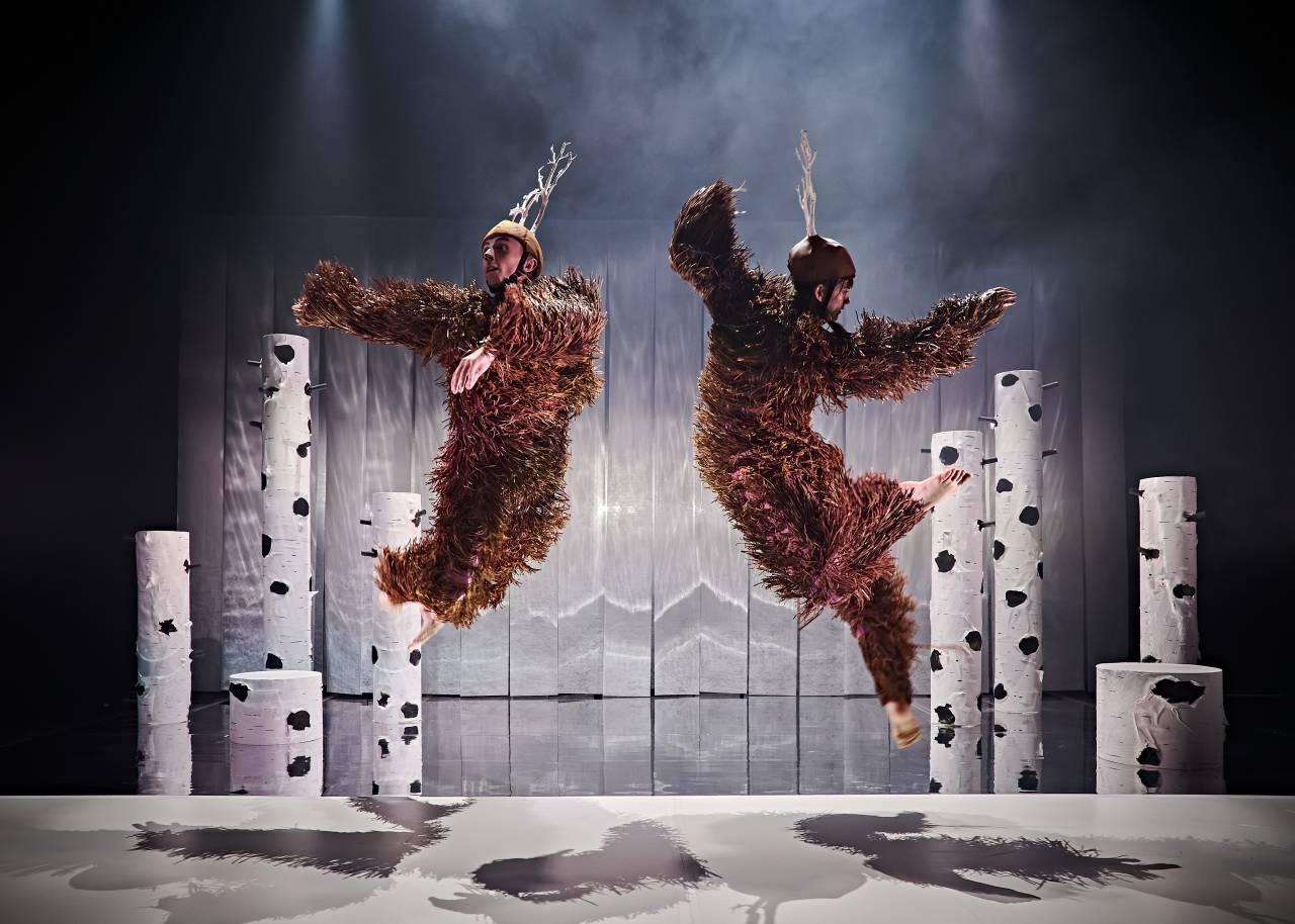 riz dressed as a deer, leaping into the air