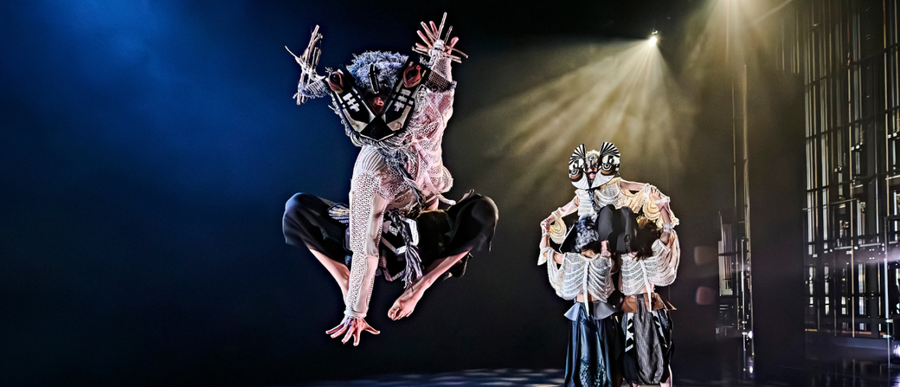 dancer in stag mask jumping high