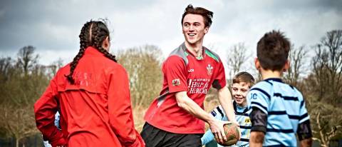 a dancer with a rugby ball about to throw it