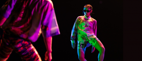 dancers under green and pink neon light